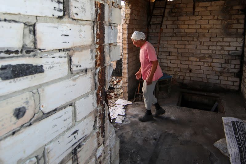 Vira Chernukha at her damaged house in the village of Dementiivka in Kharkiv region