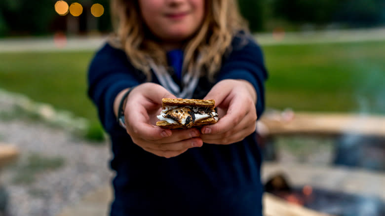 kid holding s'more