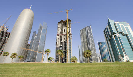 FILE PHOTO: The Doha Office Tower (L) stands next to skyscrapers under construction in Doha September 27, 2011. REUTERS/Mohammed Dabbouss/File Photo