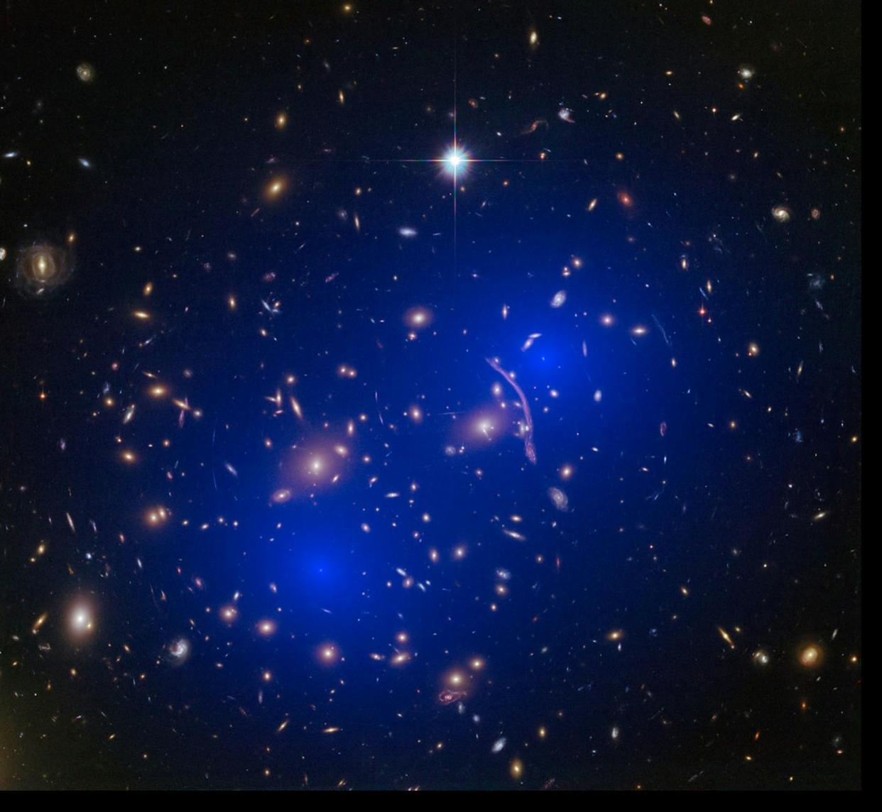 Cúmulo de galaxias Abell 370 . En la imagen se muestra en azul un mapa de la materia oscura que se encuentra dentro del cúmulo. <a href="https://esahubble.org/images/heic1506b/" rel="nofollow noopener" target="_blank" data-ylk="slk:NASA, ESA, D. Harvey (École Polytechnique Fédérale de Lausanne, Suiza), R. Massey (Universidad de Durham, Reino Unido), el equipo Hubble SM4 ERO y ST-ECF;elm:context_link;itc:0;sec:content-canvas" class="link ">NASA, ESA, D. Harvey (École Polytechnique Fédérale de Lausanne, Suiza), R. Massey (Universidad de Durham, Reino Unido), el equipo Hubble SM4 ERO y ST-ECF</a>, <a href="http://creativecommons.org/licenses/by/4.0/" rel="nofollow noopener" target="_blank" data-ylk="slk:CC BY;elm:context_link;itc:0;sec:content-canvas" class="link ">CC BY</a>