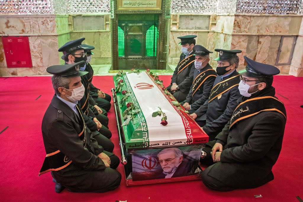 Members of Iranian forces pray around the coffin of nuclear scientist Mohsen Fakhrizadeh (TASNIM NEWS/AFP via Getty Images)