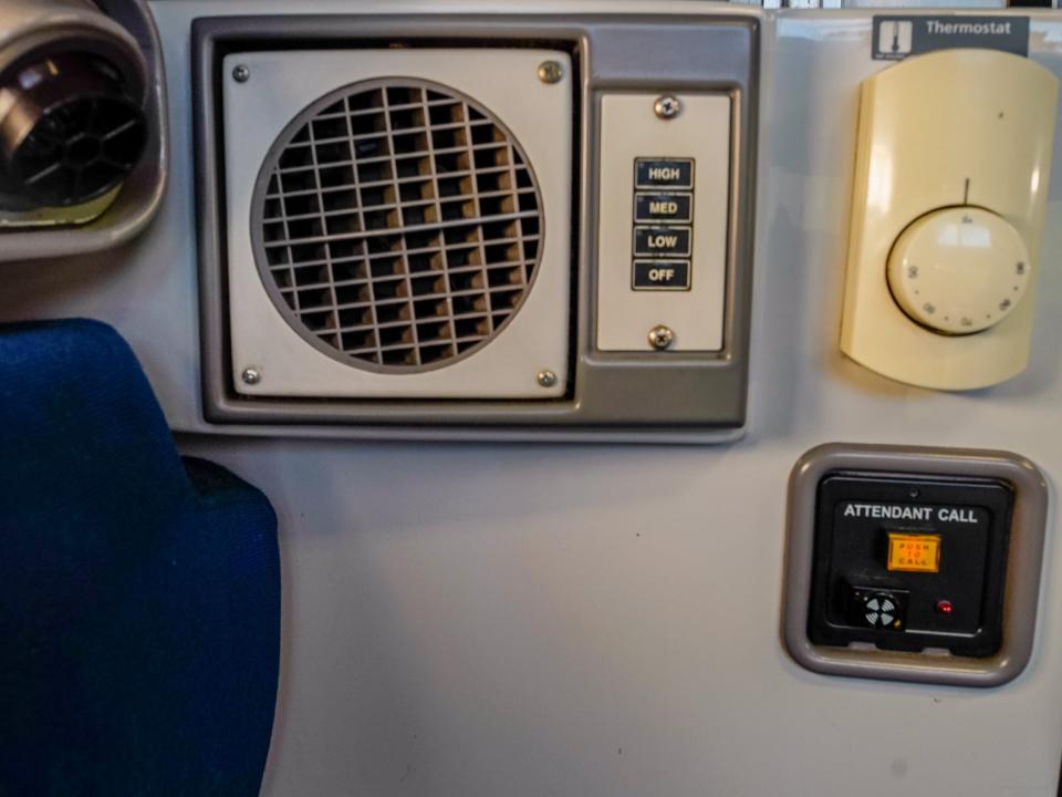 A close up of the thermometer, air conditioning, and attendant call button