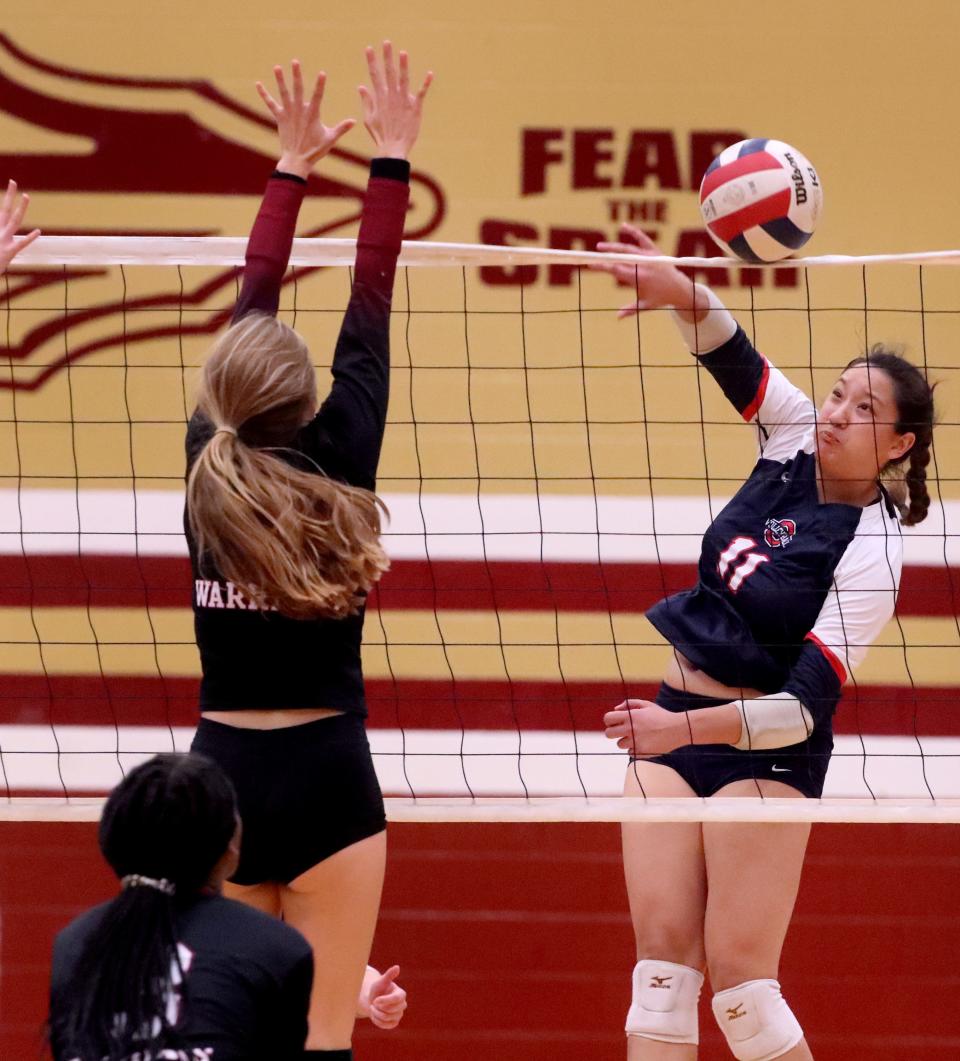 Oakland's Elisa Fries (11) hits the ball over the net s Riverdale's Norah Haney (1) defends the net on Tuesday, Sept. 13, 2022, at Riverdale.