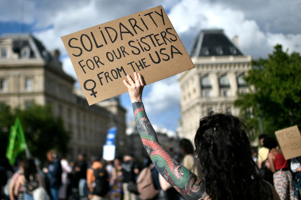 Image: A protestor holds a sign during a rally in support of worldwide abortion rights in Paris, after the U.S. Supreme Court's overturned Roe v. Wade, on June 24, 2022. (Stephane de Sakutin / AFP - Getty Images)