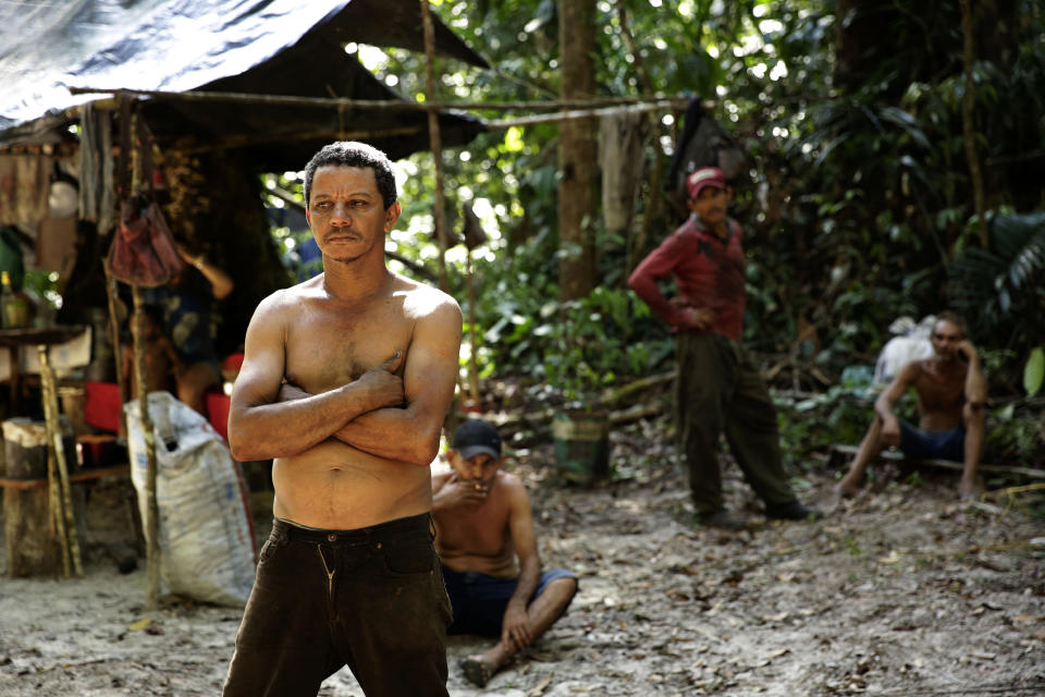 Zeca Pilao, leader of an illegal logger camp, talks with Tenetehara Indigenous men from the Ka'Azar, or Forest Owners, who discovered the encampment while patrolling their lands on the Alto Rio Guama reserve in Para state, near the city of Paragominas, Brazil, Tuesday, Sept. 8, 2020. Three Tenetehara Indigenous villages are patrolling to guard against illegal logging, gold mining, ranching, and farming as increasing encroachment and lax government enforcement during COVID-19 have forced the tribe to take matters into their own hands. (AP Photo/Eraldo Peres)