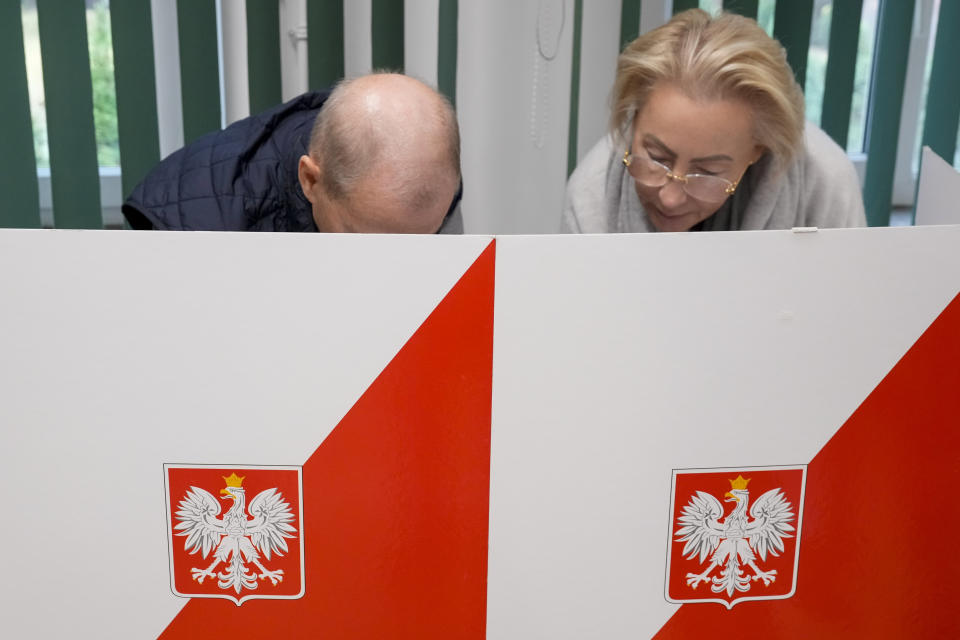 People prepare ballots for a parliamentary elections in Warsaw, Poland, Sunday, Oct. 15, 2023. Poland is holding an election Sunday that many see as its most important one since the 1989 vote that toppled communism. At stake are the health of the nation's democracy, its legal stance on LGBTQ+ rights and abortion, and the foreign alliances of a country on NATO's eastern flank that has been a crucial ally to Ukraine. (AP Photo/Czarek Sokolowski)