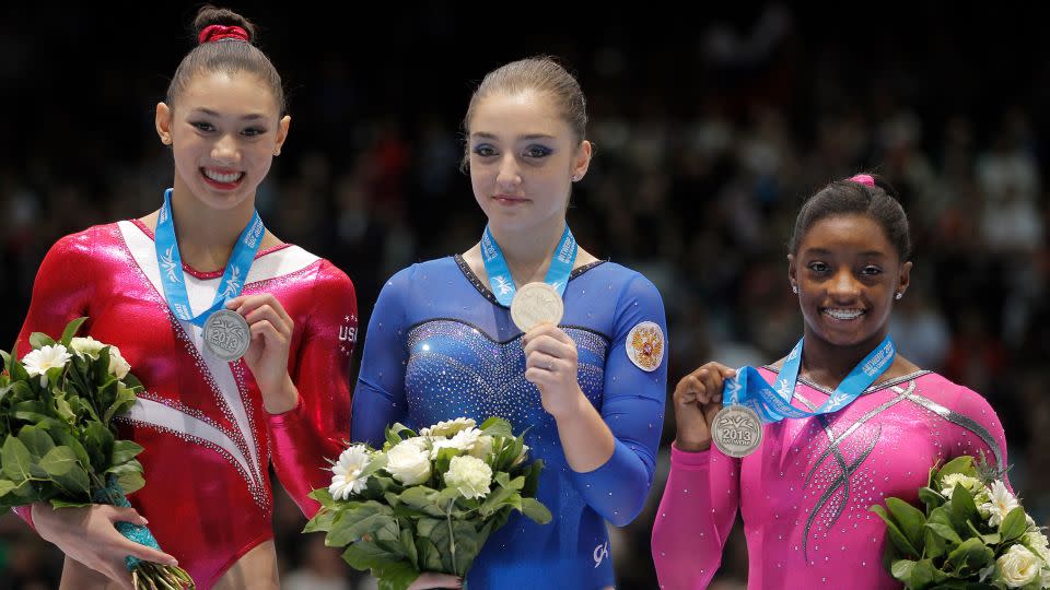 Biles (right) poses with her bronze medal during the award ceremony for the balance beam exercise after the apparatus final at the World Championships in Antwerp, Belgium, in 2013. - Yves Logghe/AP