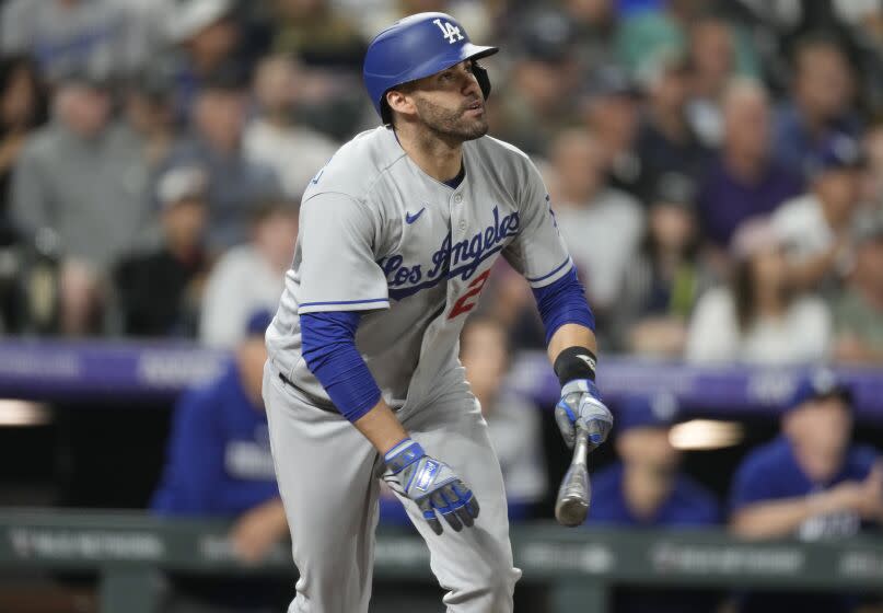 Los Angeles Dodgers' J.D. Martinez watches his two-run home run against the Colorado Rockies during the fourth inning of a baseball game Thursday, June 29, 2023, in Denver. (AP Photo/David Zalubowski)
