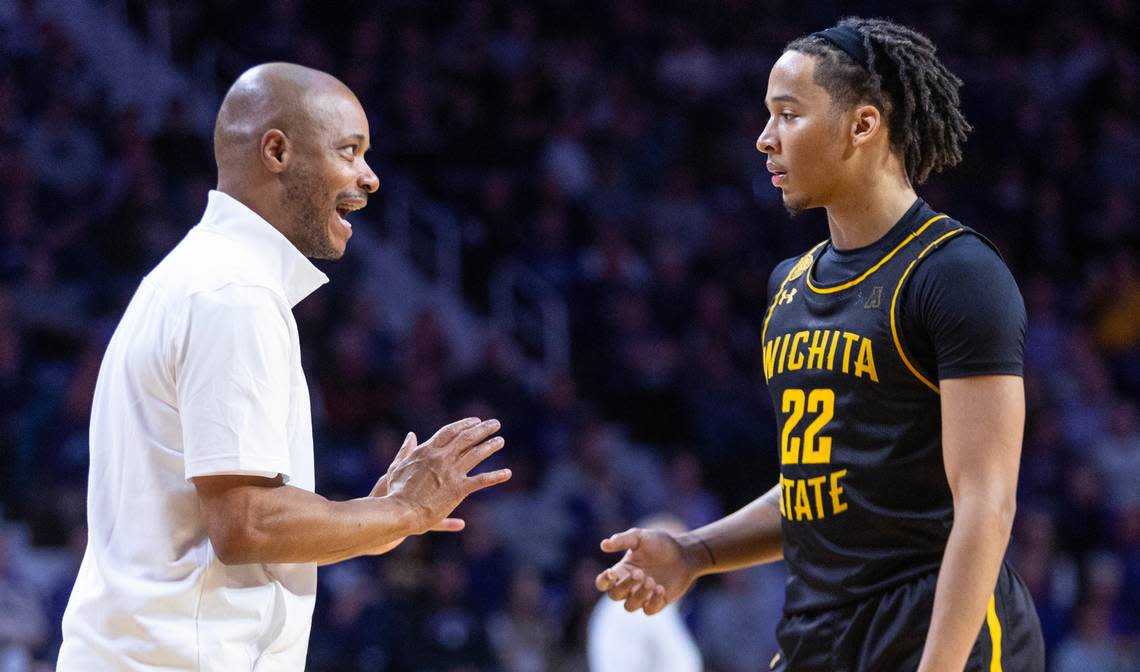 Wichita State coach Isaac Brown talks with guard Shammah Scott during the second half against Kansas State on Saturday.