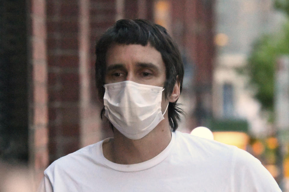 Richard Pusey walks on the street after being granted bail in Melbourne on Oct. 16, 2020. Pusey was sentenced to 10 months in prison on Wednesday, April 28, 2021, for offenses including what a judge described as the "heartless, cruel and disgraceful" filming of four dead and dying police officers who had just been hit by a truck on an Australian freeway. (James Ross/AAP Image via AP)