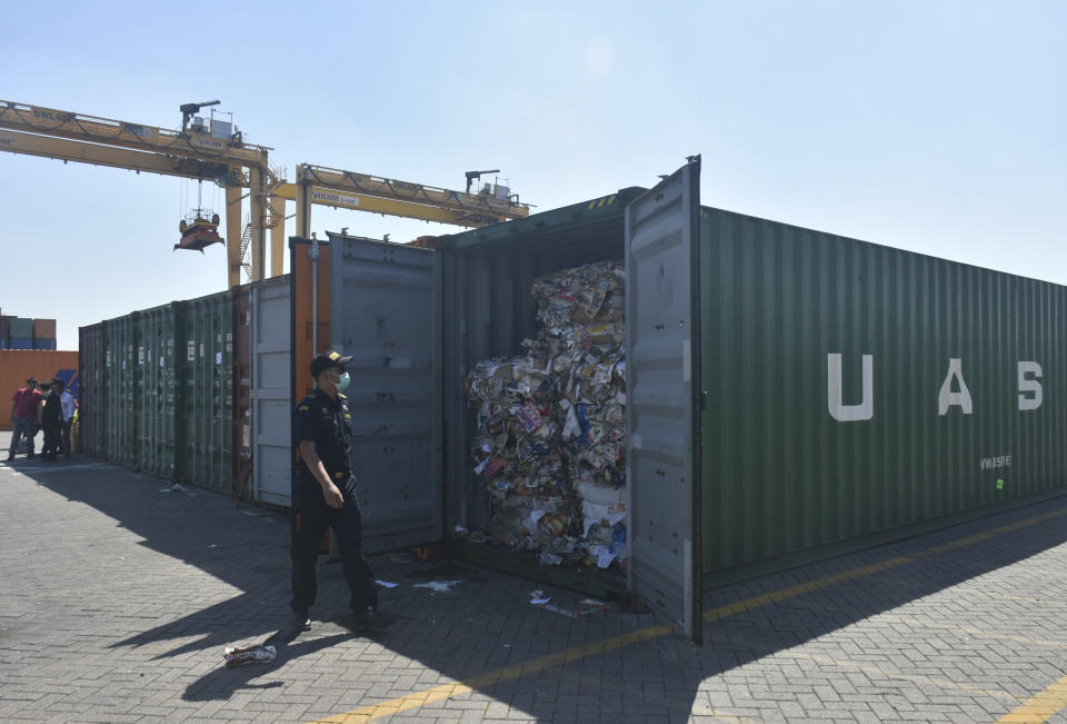 Indonesian custom officers open containers full of waste at the Tanjung Perak port in Surabaya, East Java, Indonesia, Tuesday, July 9, 2019. Indonesia is sending dozens of containers of imported waste back to Western nations after finding it was contaminated with used diapers, plastic and other materials, adding to a growing backlash in Southeast Asia against being a dumping ground for the developed world's rubbish.(AP Photo)