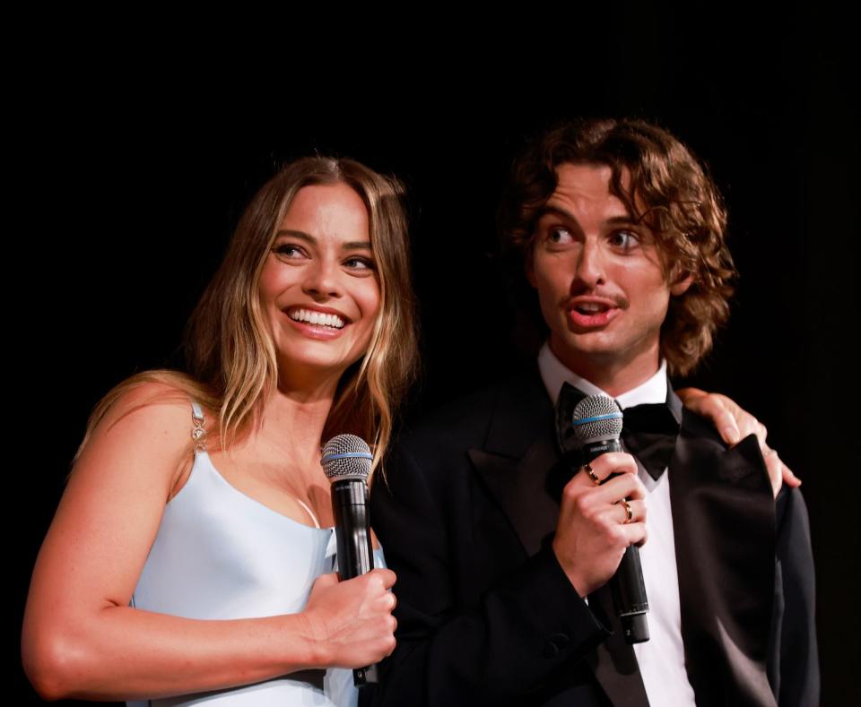 <p>Hanna Lassen/Getty</p> Margot Robbie attends the Australian premiere of "Babylon" with her younger brother, Cameron Robbie, in January 2023.