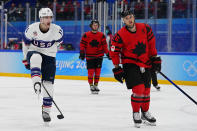 United States' Kenny Agostino (11) celebrates after scoring a goal against Canada during a preliminary round men's hockey game at the 2022 Winter Olympics, Saturday, Feb. 12, 2022, in Beijing. At right is Canada's Maxim Noreau (56). (AP Photo/Matt Slocum)