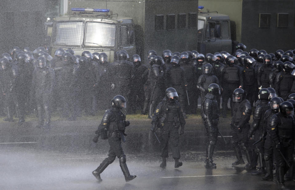 Police block the road to against an opposition rally protesting the official presidential election results in Minsk, Belarus, Sunday, Oct. 4, 2020. Hundreds of thousands of Belarusians have been protesting daily since the Aug. 9 presidential election. (AP Photo)