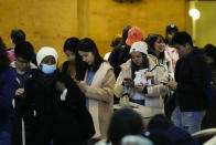 Travelers wait in line to board an Amtrak train ahead of the Thanksgiving Day holiday at 30th Street Station in Philadelphia, Wednesday, Nov. 22, 2023. (AP Photo/Matt Rourke)