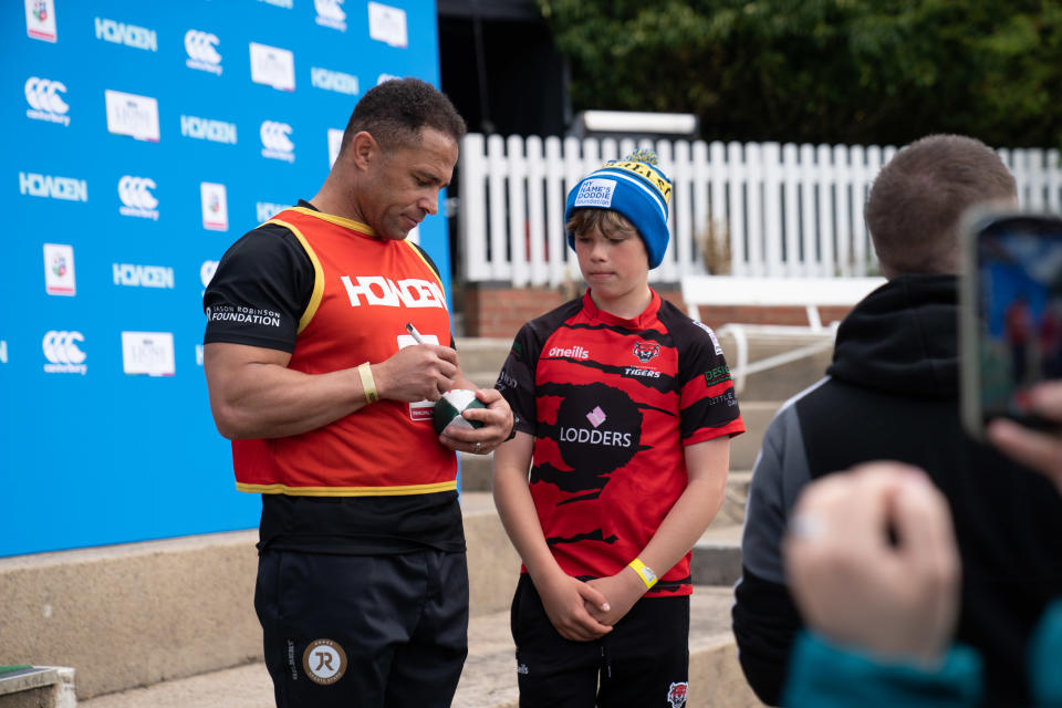 A young Cheltenham Tigers player with Jason Robinson