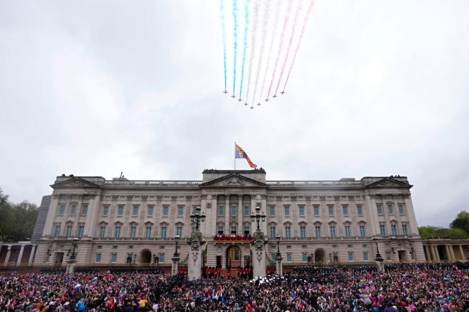 King Charles III and Queen Camilla on the balcony of Buckingham Palace watching the Royal Air Force Red Arrows fly over after their coronation ceremony, in London on May 6, 2023. AP
