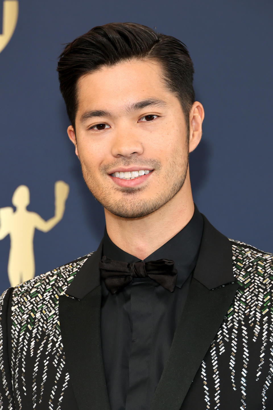 A closeup of Ross Butler smiling