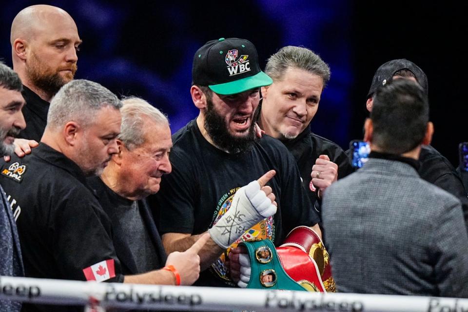 Beterbiev (centre) celebrates his stoppage win over Callum Smith (Getty Images)