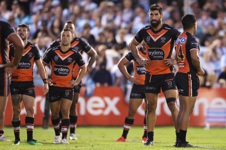 Pictured second from right, Tigers co-captain James Tamou and his teammates look dejected during the round five loss to Cronulla in the NRL. 