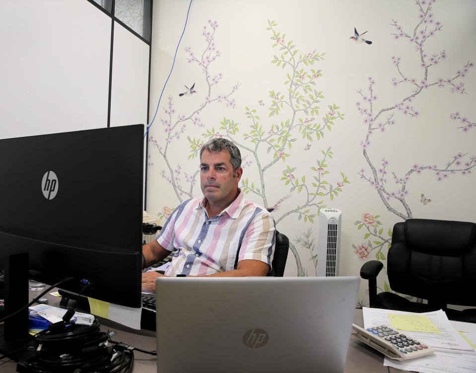 Tempaper CFO Tom Sessa works in his office in front of a wall decorated with one of the company's products Monday, July 18, 2022. The Brick business sells peel-and-stick wallpaper in a variety of patterns and prices.