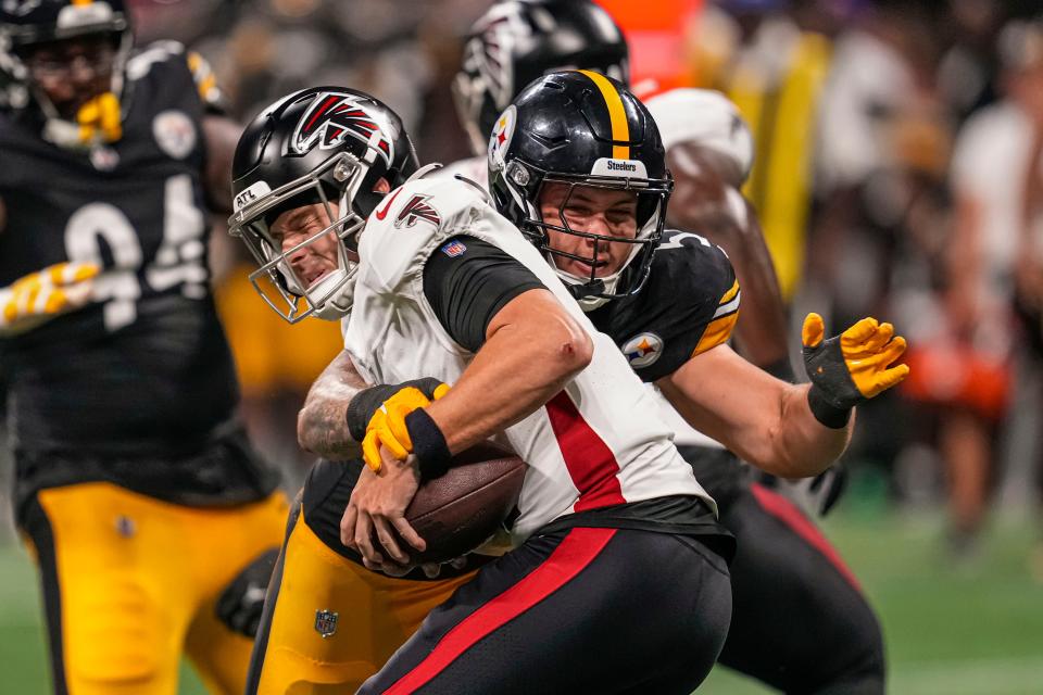 Steelers linebacker Nick Herbig (51) sacks Atlanta Falcons quarterback Logan Woodside (11) during the second half at Mercedes-Benz Stadium on Aug. 24, 2023.