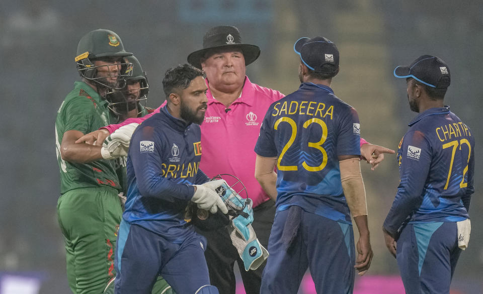 An umpire intervenes as Bangladesh players and Sri Lankan players get into an altercation during the ICC Men's Cricket World Cup match between Bangladesh and Sri Lanka in New Delhi, India, Monday, Nov. 6, 2023. (AP Photo/Manish Swarup)