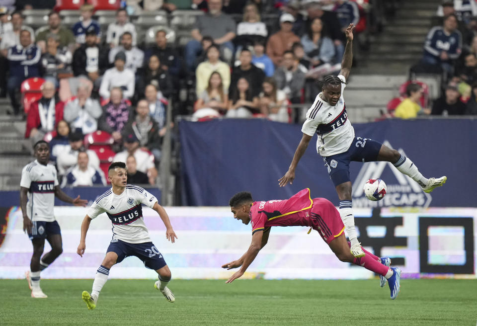 Vancouver Whitecaps' Javain Brown, top and St. Louis City's Nicholas Gioacchini vie for the ball during the first half of an MLS soccer match Wednesday, Oct. 4, 2023, in Vancouver, British Columbia. (Darryl Dyck/The Canadian Press via AP)
