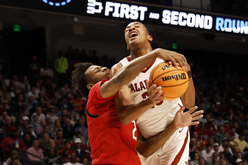 Maryland guard Jahari Long (2) ties up the ball as Alabama guard Nimari Burnett, right, goes up to shoot in the first half of a second-round college basketball game in the NCAA Tournament in Birmingham, Ala., Saturday, March 18, 2023. (AP Photo/Butch Dill)