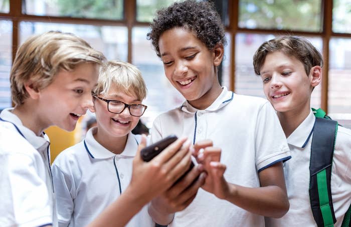 A group of students looking at a phone