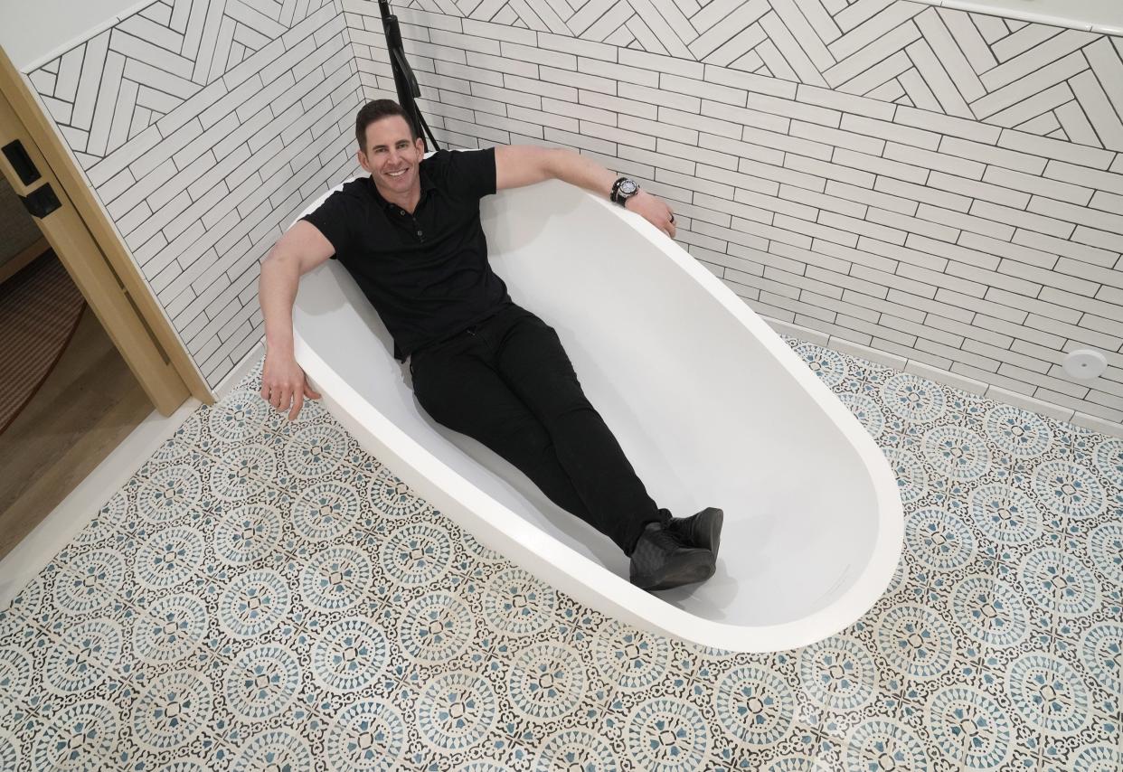 Tarek El Moussa, a real estate entrepreneur and persona on HGTV's hit shows "Flipping 101" and "Flip or Flop," poses in a bathtub at the Arizona Biltmore in Phoenix on April 11, 2023, while promoting his upcoming Flipping Summit.