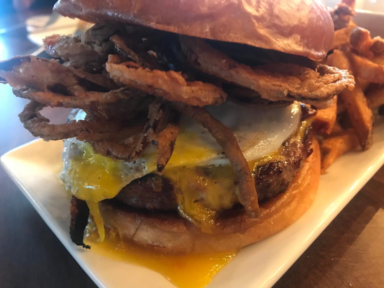 The Breakfast on the Farm burger at BRIX features a fried egg and haystack onions.