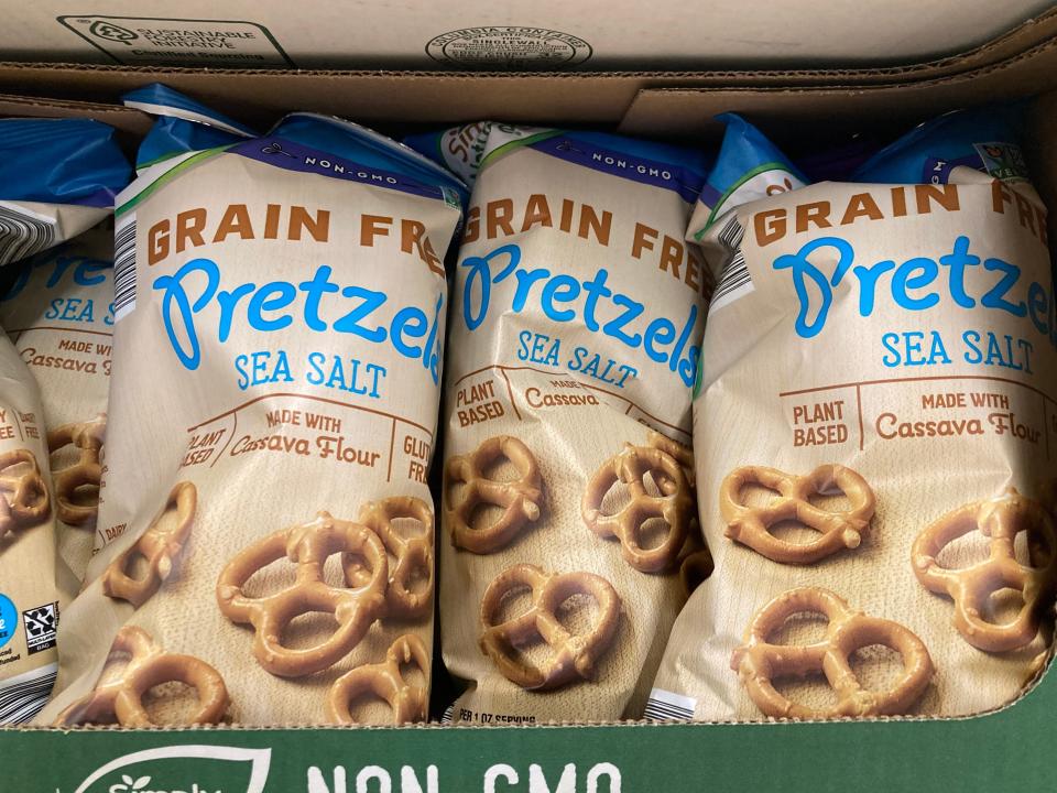 blue and beige bags of simply nature's grain-free pretzels on Aldi shelf