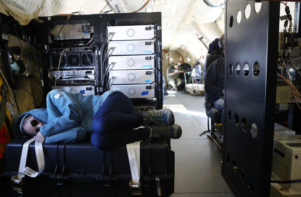 <p>USGS field geophysicist Katrina Zamudio rests on the return leg of a nine-hour sea ice flight aboard NASA’s Operation IceBridge research aircraft in the Antarctic Peninsula region on Nov. 4, 2017, above Antarctica. (Photo: Mario Tama/Getty Images) </p>