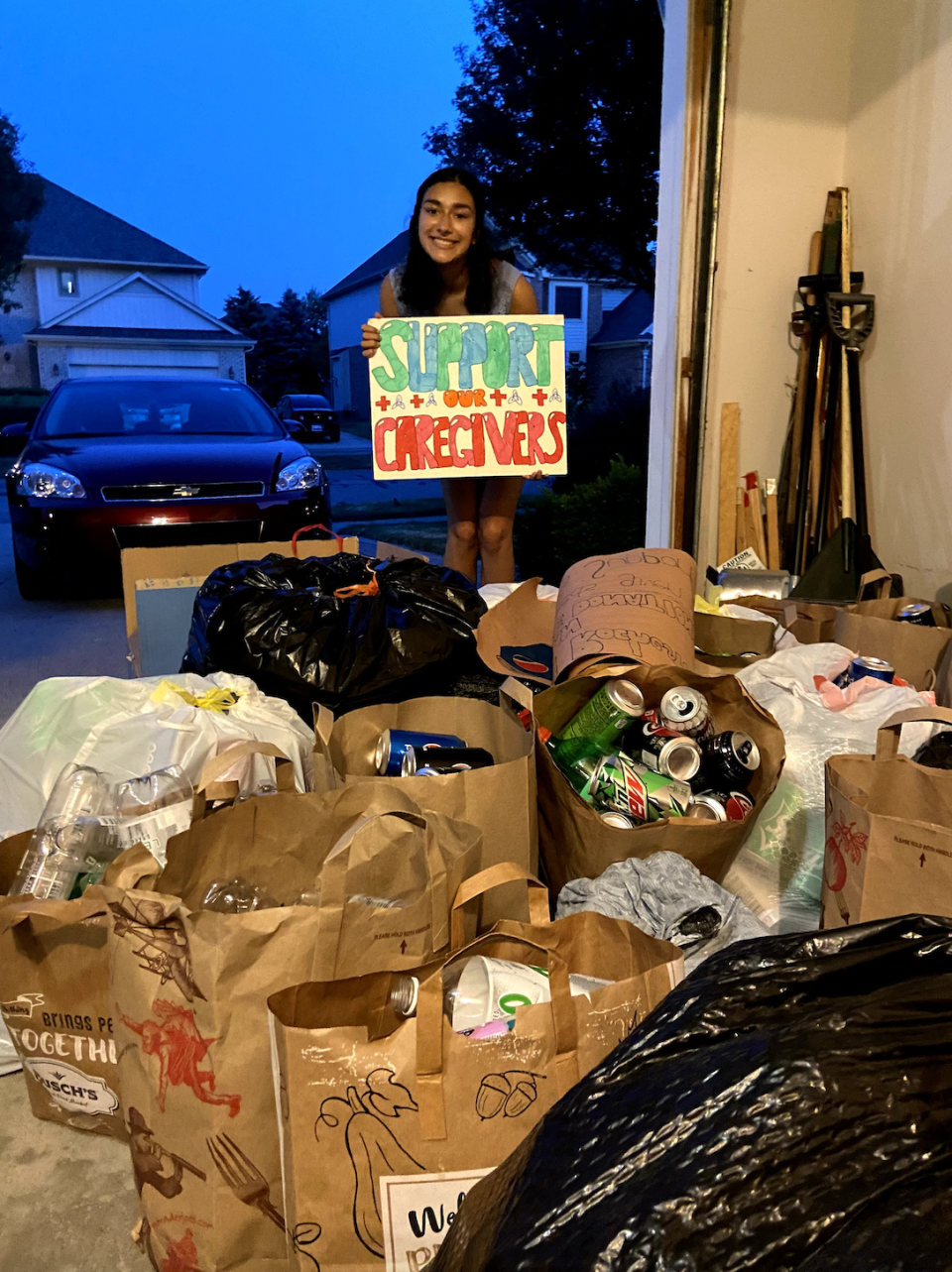 Sanya Gupta of Rochester Hills with cans for a drive to benefit front-line health care workers. She started Rebuild Rochester, an online tutoring program, during the COVID-19 pandemic.