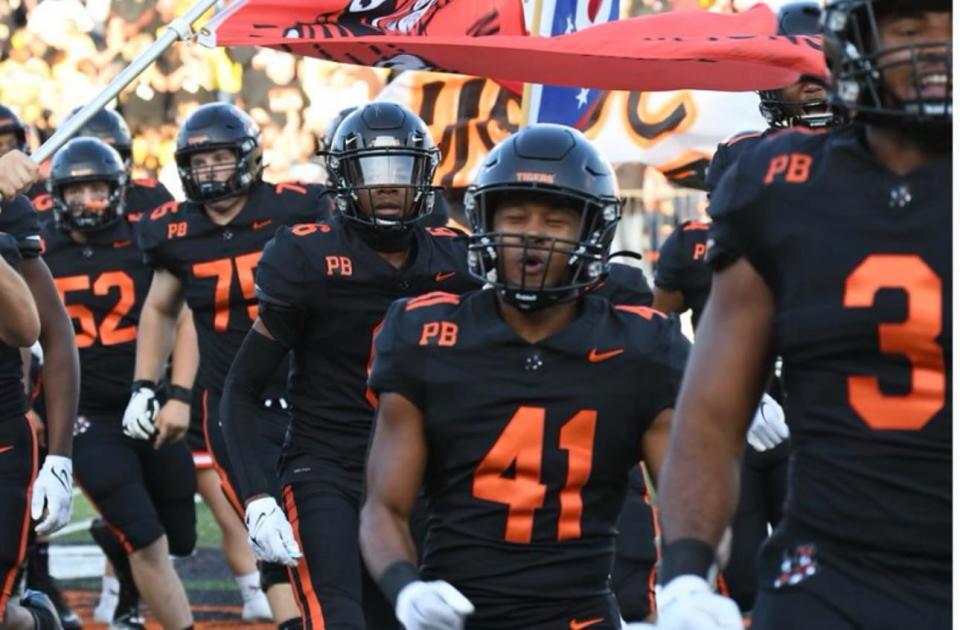 Massillon linebacker Shon Robinson (41) takes the field with teammates before a 2023 home game.