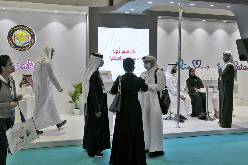 Visitors and exhibitors wear masks at the Arab Health Exhibition in Dubai, United Arab Emirates, Wednesday, Jan. 29, 2020. The United Arab Emirates on Wednesday confirmed the first cases in the Mideast of the new Chinese virus that causes flu-like symptoms, saying doctors now were treating a family that had just come from a city at the epicenter of the outbreak. (AP Photo/Kamran Jebreili)