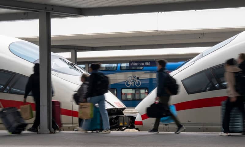 Passengers walk past one of the few long-distance trains running at Munich's main station, during a strike by the German Train Drivers' Union (GDL). The GDL has called for a further 24-hour strike in both passenger and freight transport. Peter Kneffel/dpa