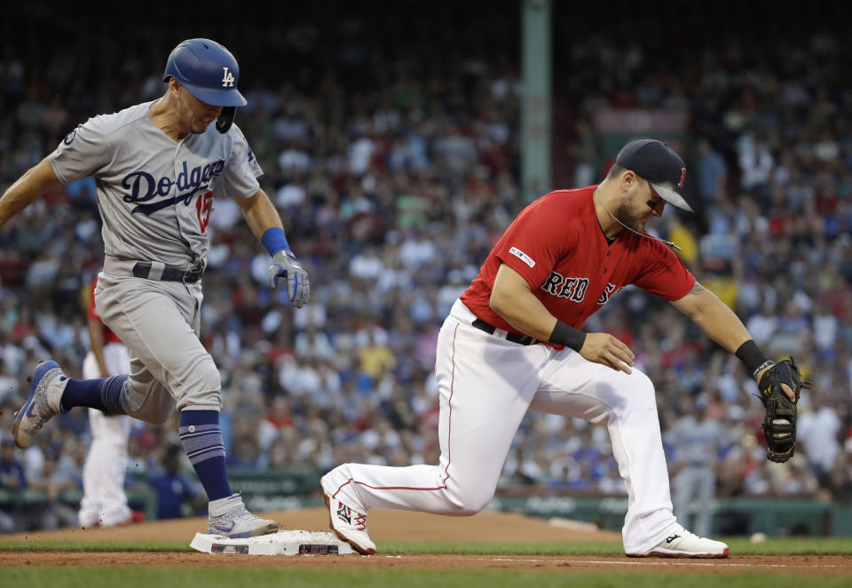 Los Angeles Dodgers' Austin Barnes is out at first on a ground ball as Boston Red Sox first baseman Michael Chavis catches the throw from third during the second inning of a baseball game at Fenway Park, Friday, July 12, 2019, in Boston. (AP Photo/Elise Amendola)