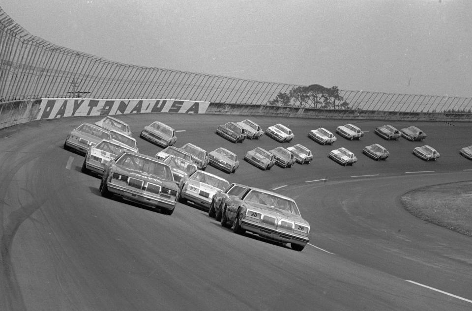 FILE - In this Feb. 18, 1979, file photo, 41 cars roll around the wet Daytona International Speedway track under a caution flag as the Daytona 500 auto race gets under way in Daytona Beach, Fla. The 1979 race was instrumental in broadening NASCAR's southern roots. Forty years later, it still resonates as one of the most important days in NASCAR history. (AP Photo, File)