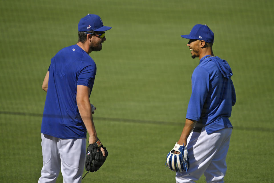 Los Angeles Dodgers center fielder Cody Bellinger, left, talks with right fielder Mookie Betts during the restart of baseball spring training Sunday, July 5, 2020, in Los Angeles. (AP Photo/Mark J. Terrill)