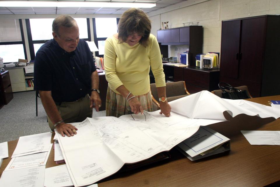 Ned Panfile Sr. (left) and Manville Superintendent Johanna S. Ruberto look over plans for the turf football field on Aug. 12, 2010.