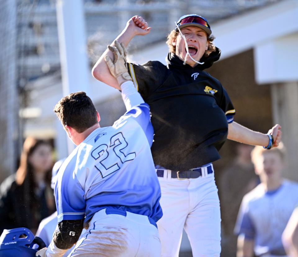 Brady Meyer (22) celebrates with a St. John Paul II teammates on Wednesday, May 3, 2023.