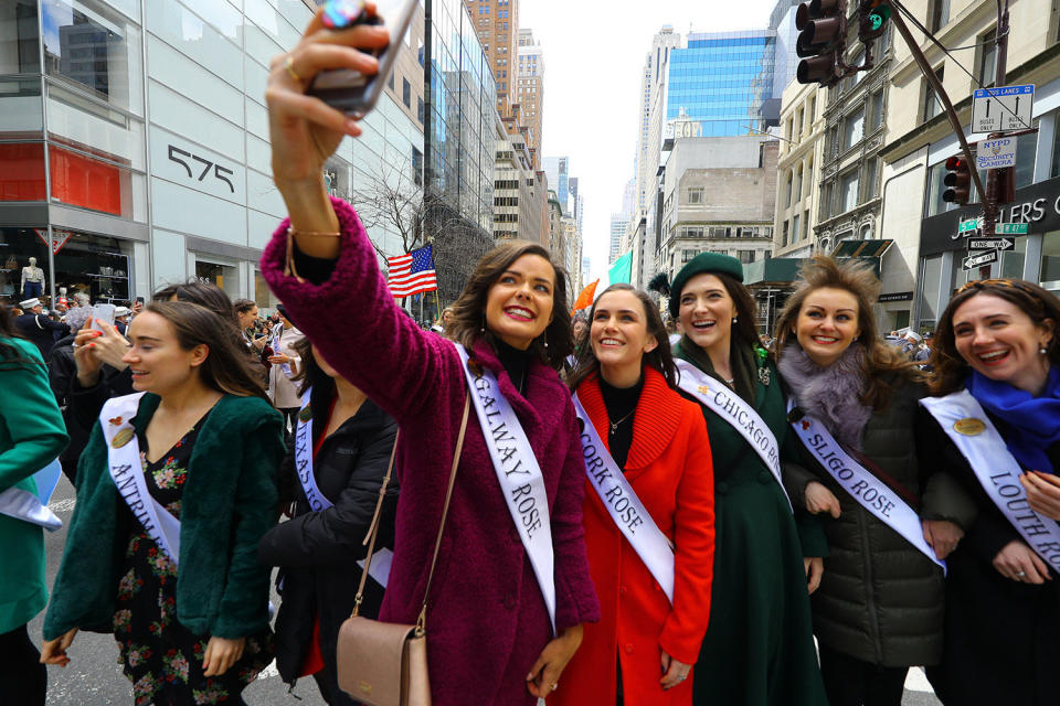 A woman takes a selfie with friends during a break while  marching in the St. Patrick's Day Parade in New York City, March 16, 2019. (Photo: Gordon Donovan/Yahoo News)