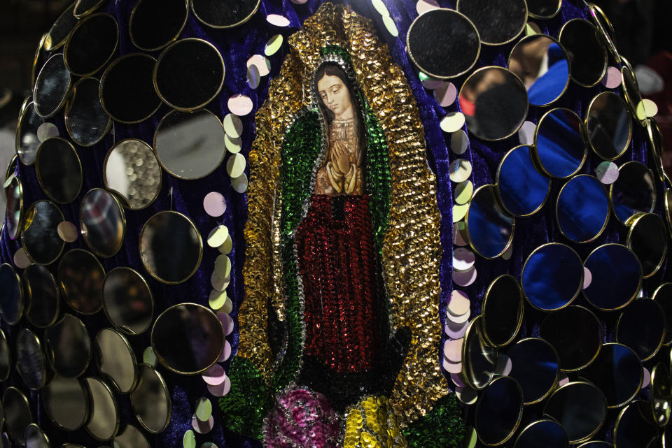 Un hombre usa un disfraz con una imagen de la Virgen de Guadalupe durante una Muerteada en San Agustín Etla el jueves 2 de noviembre de 2023. Los mexicanos en el pueblo oaxaqueño celebran la tradicional Muerteada, una recreación teatral que se representa durante la noche del 1 de noviembre hasta la madrugada del día siguiente, con bailes y música desfilando por las calles, mientras se cuenta la historia de cómo un difunto resucita con la ayuda de un sacerdote, un médico y un espiritista. (AP Foto/Maria Alferez)