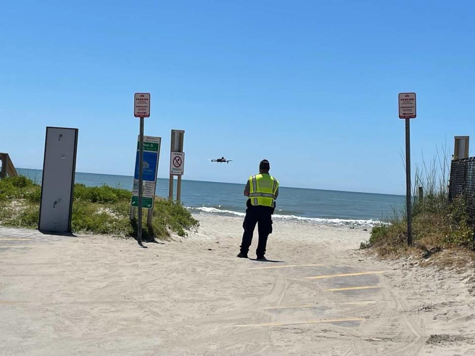 The South Carolina Highway Patrol flies a drone at the Nash Street beach access outside of Myrtle Beach, S.C., Friday, June 14, 2024, as officers investigate the deadly crash involving a beachgoer and a patrol vehicle of the Horry County Sheriff's Office.  A woman was hit by the car and later died from her injuries.