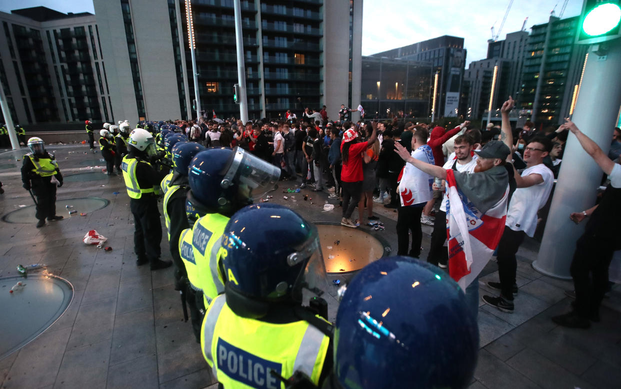 Soccer Football - Euro 2020 - Final - Fans gather for Italy v England - Wembley Stadium, London, Britain - July 11, 2021 Police officers stand guard as England fans gather during the match Action Images via Reuters/Peter Cziborra