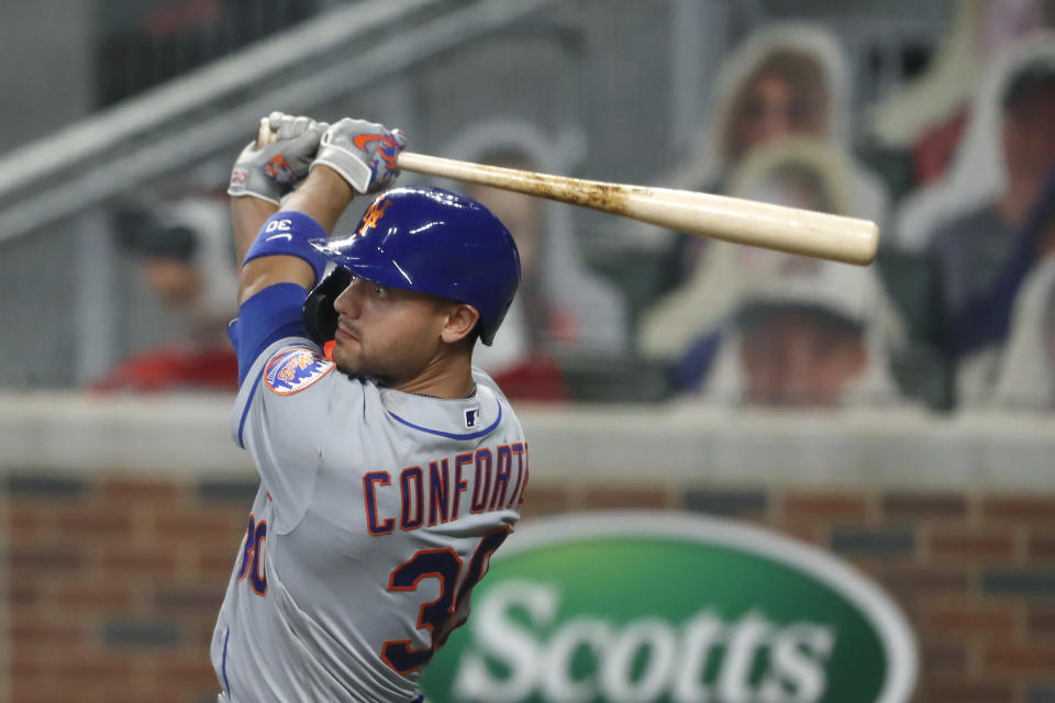 New York Mets' Michael Conforto (30) follows through on a ground rule double in the seventh inning of a baseball game against the Atlanta Braves Monday, Aug. 3, 2020, in Atlanta. (AP Photo/John Bazemore)