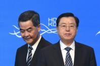 Hong Kong Chief Executive Leung Chun-ying (L) walks past Zhang Dejiang (R), who chairs China's communist-controlled legislature, as they open the Belt and Road Summit in Hong Kong on May 18, 2016