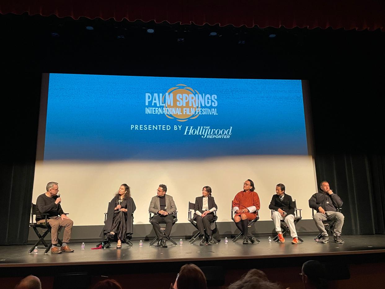 From left, moderator Kevin Cassidy, "The Mother of All Lies" director Asmae El Moudir, "Society of the Snow" director J.A. Bayona, "Tótem" director Lila Avilés, "The Monk and the Gun" director Pawo Choyning Dorji, "The Taste of Things" director Trần Anh Hùng and "Io Capitano" director Matteo Garrone at an international directors panel hosted by the Palm Springs International Film Festival on Jan. 8, 2024.